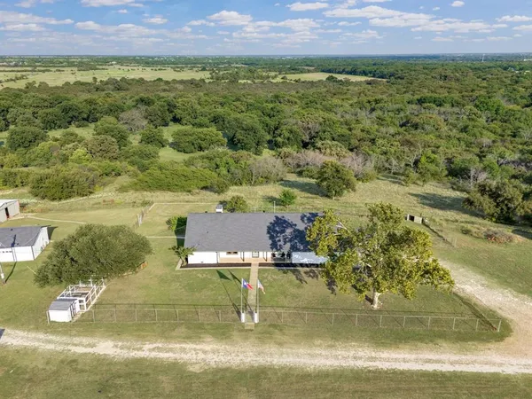an aerial view of a house with a yard