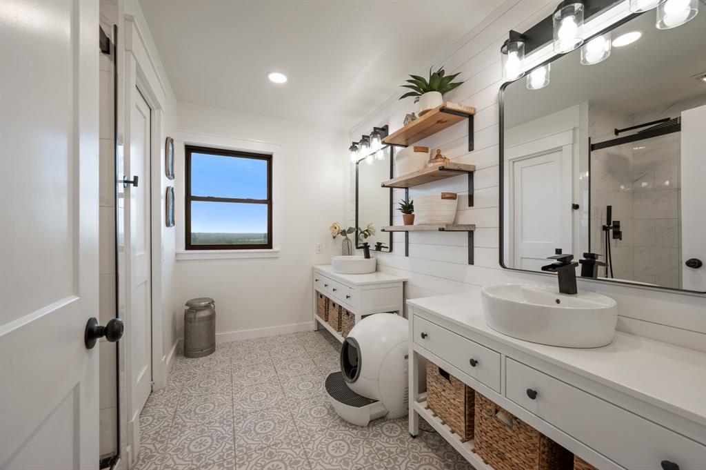 10902 Clear Creek Road West Sanger, TX 76266 - Photo 17 of 40 Bathroom with two vanities, a stall shower, and recessed lighting