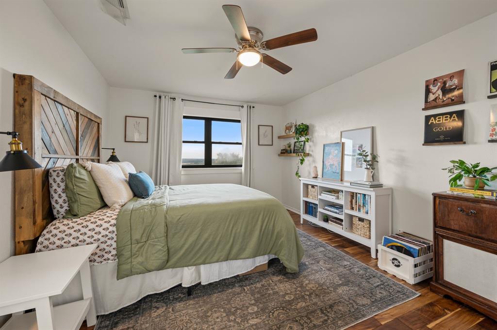 10902 Clear Creek Road West Sanger, TX 76266 - Photo 18 of 40 Bedroom featuring dark wood finished floors and a ceiling fan