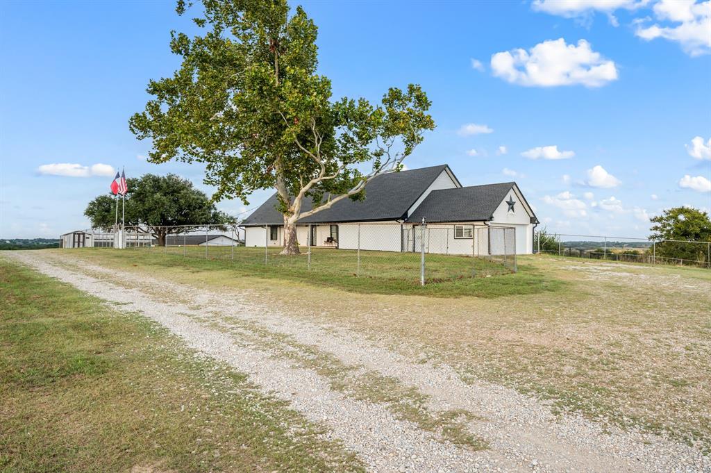 10902 Clear Creek Road West Sanger, TX 76266 - Photo 19 of 40 a view of a house with a yard