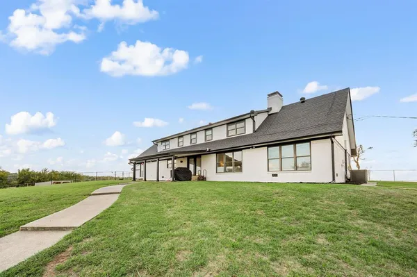 a view of a house with a back yard