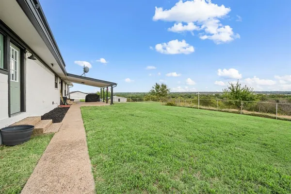 a backyard of a house with lots of green space