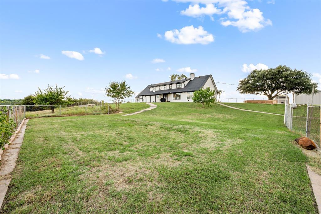 10902 Clear Creek Road West Sanger, TX 76266 - Photo 23 of 40 a backyard of a house with lots of green space
