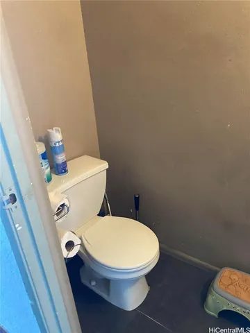 a white toilet sitting next to a sink