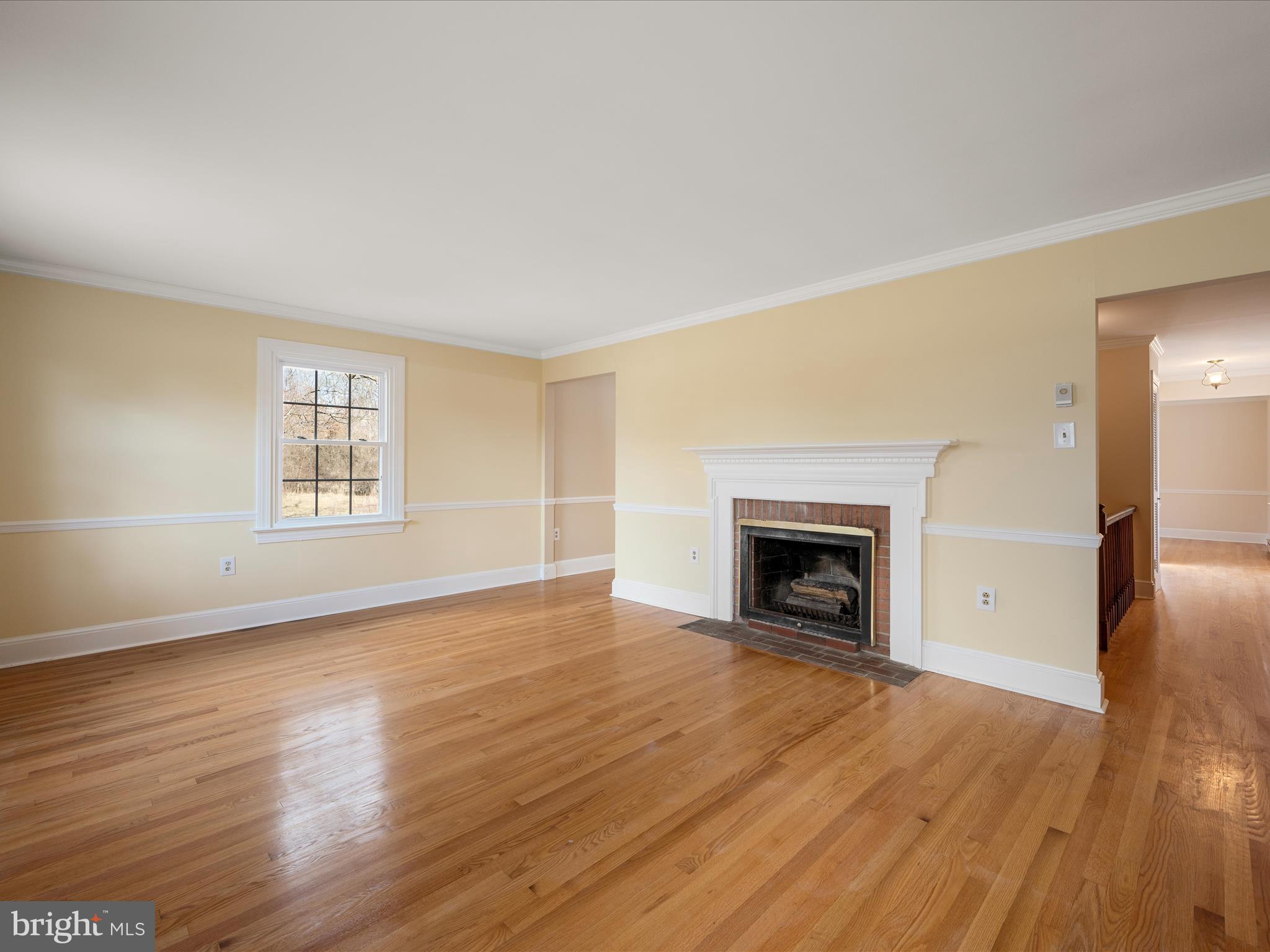 237 Summerville Road Boyce, VA 22620 - Photo 14 of 53 an empty room with wooden floor fireplace and windows