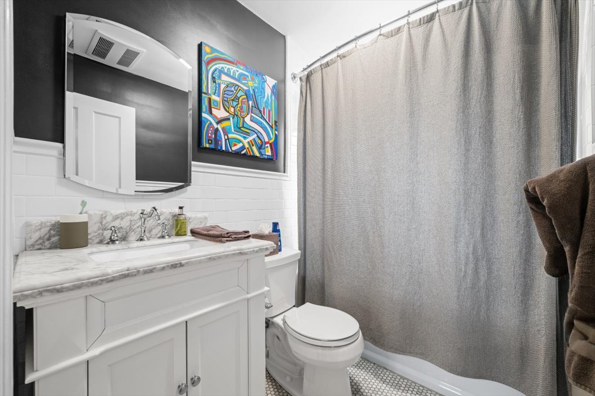 198 Wildwood Road Lake Forest, IL 60045 - Photo 24 of 37 a bathroom with a granite countertop sink toilet and mirror