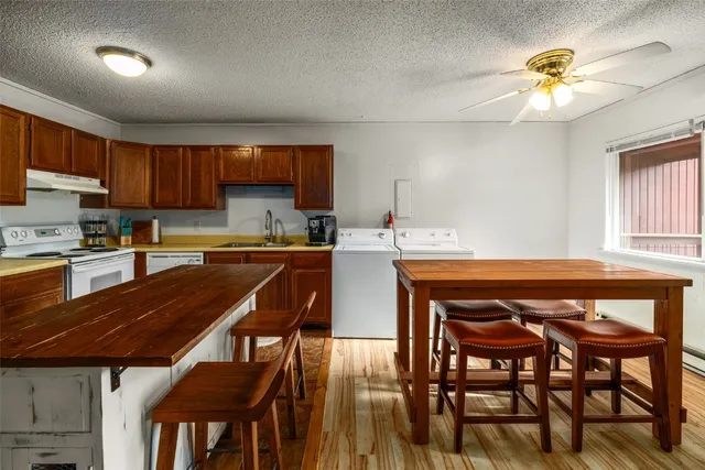 a kitchen with a table chairs and a refrigerator