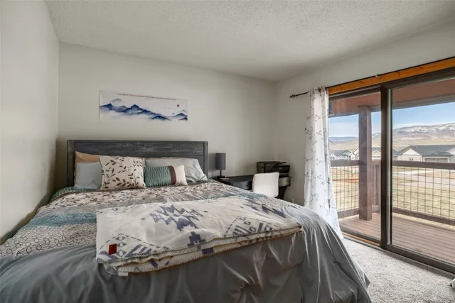 a bedroom with a large bed and a balcony view