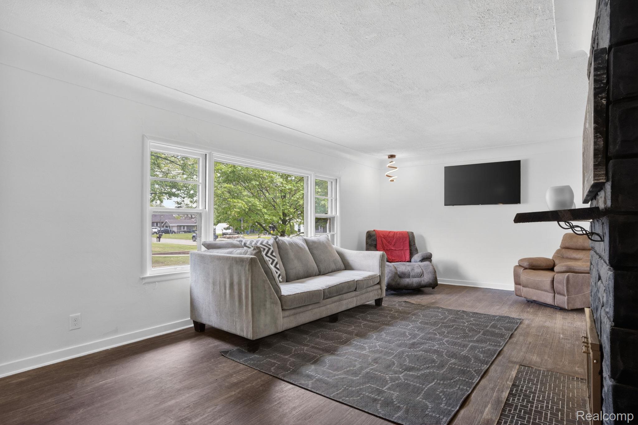 1209 Beatrice Street Flushing, MI 48433 - Photo 16 of 39 Living room featuring dark wood finished floors and a textured ceiling