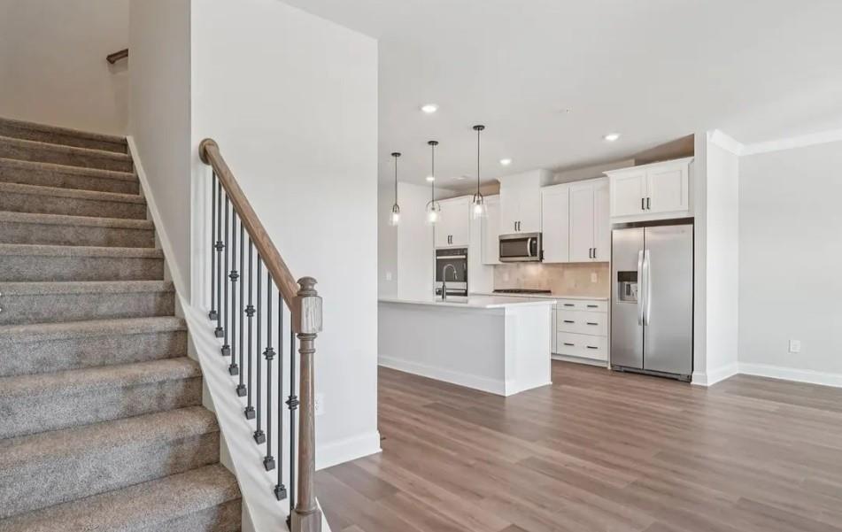 6060 Molo Lane Cumming, GA 30041 - Photo 5 of 14 a view of kitchen with wooden floor and electronic appliances