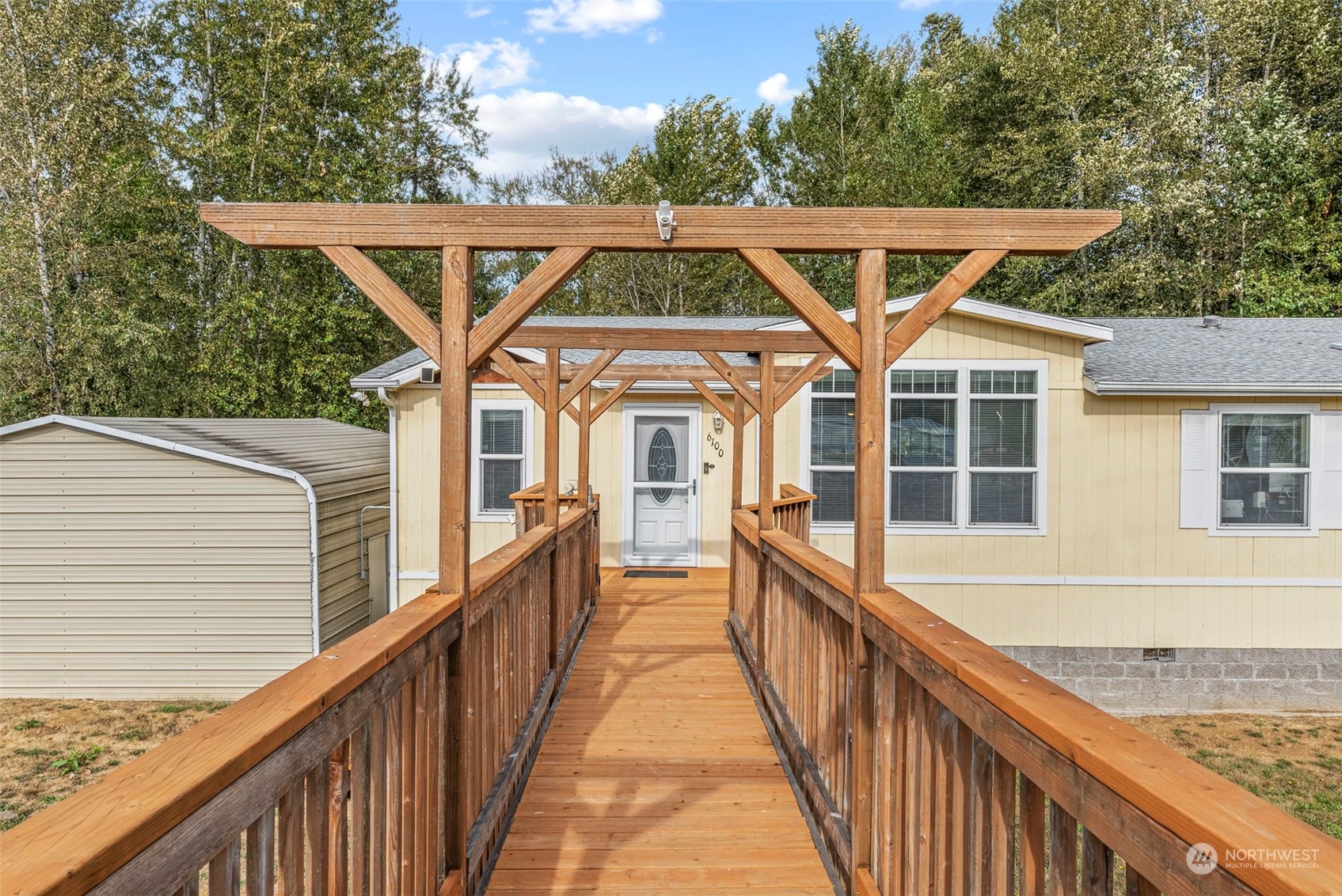 6100 Willow Grove Road Longview, WA 98632 - Photo 29 of 35 a view of a house with wooden deck and a forest
