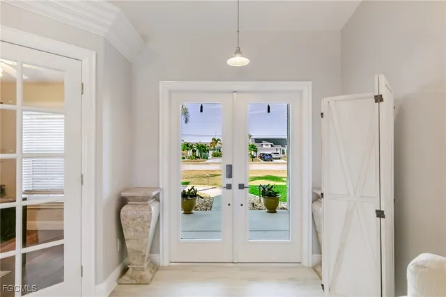 a living room with furniture a fireplace and a chandelier