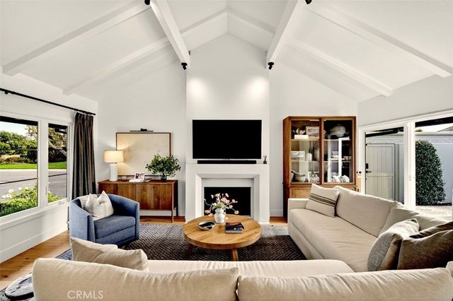 a living room with fireplace furniture and a flat screen tv