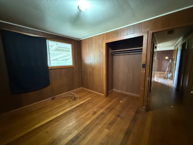 a work room with wooden floor and a window