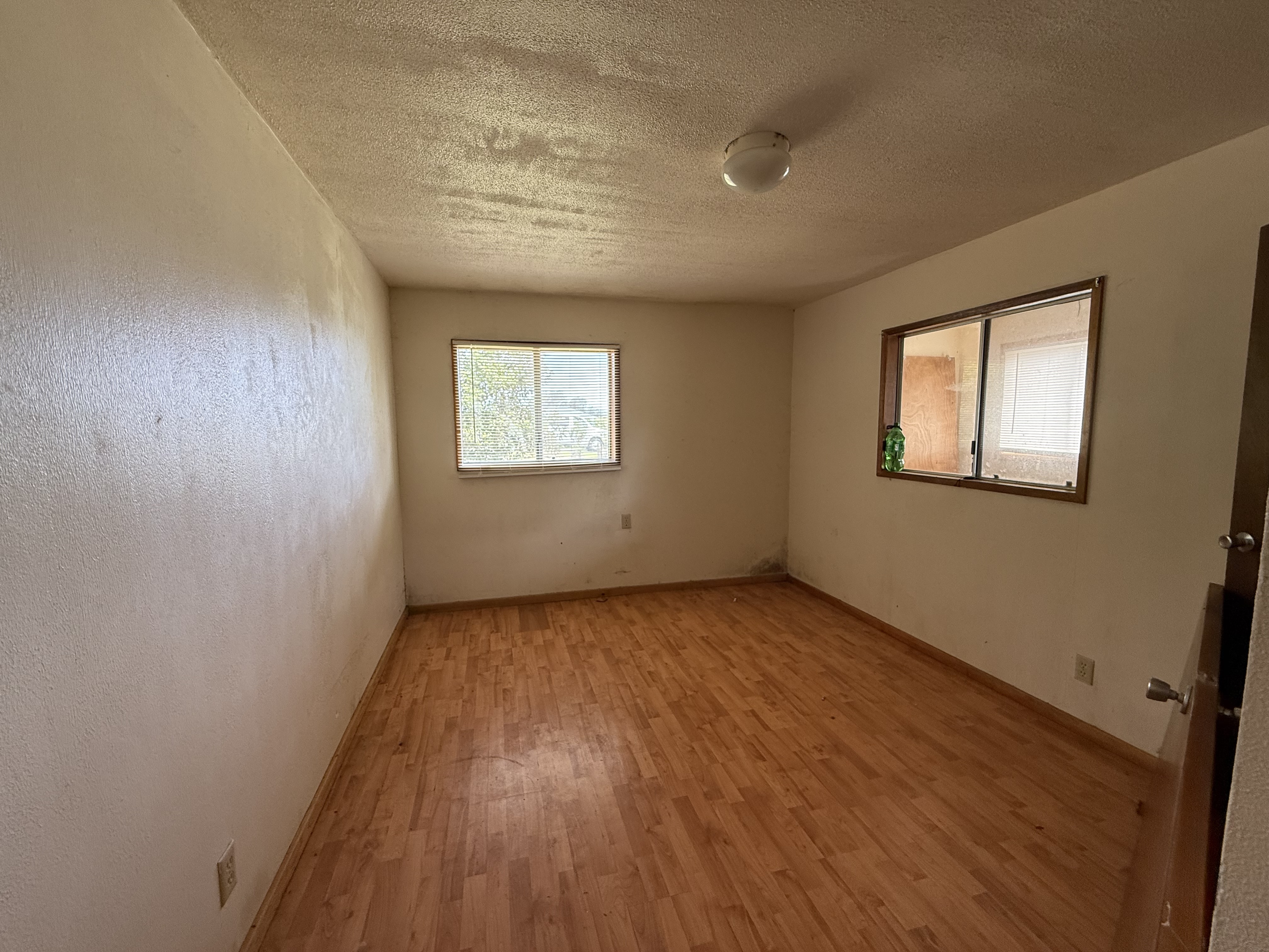 64-5231 White Road Kamuela, HI 96743 - Photo 13 of 15 a view of an empty room with wooden floor and a window