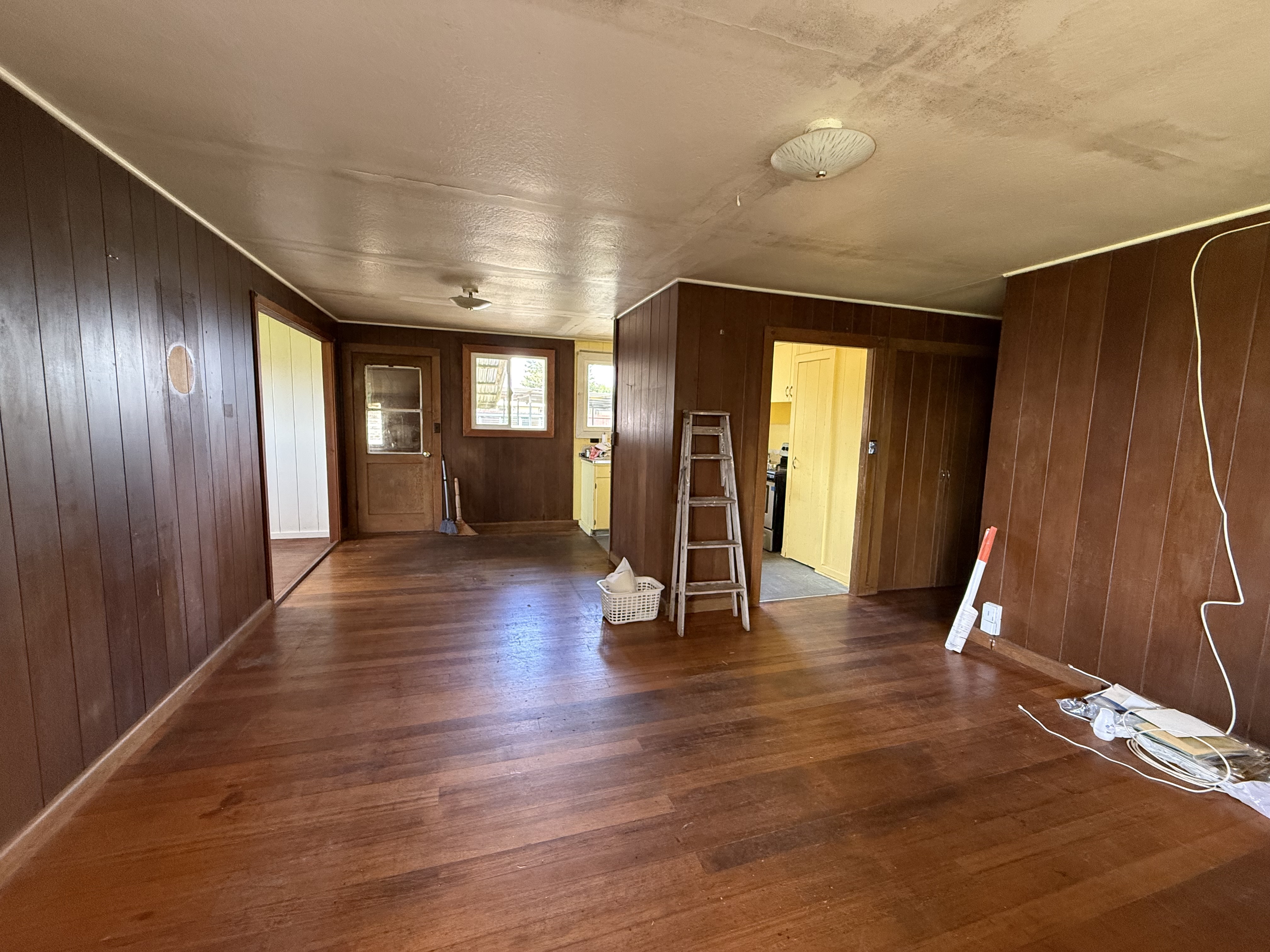 64-5231 White Road Kamuela, HI 96743 - Photo 4 of 15 a view of an empty room with wooden floor and a window