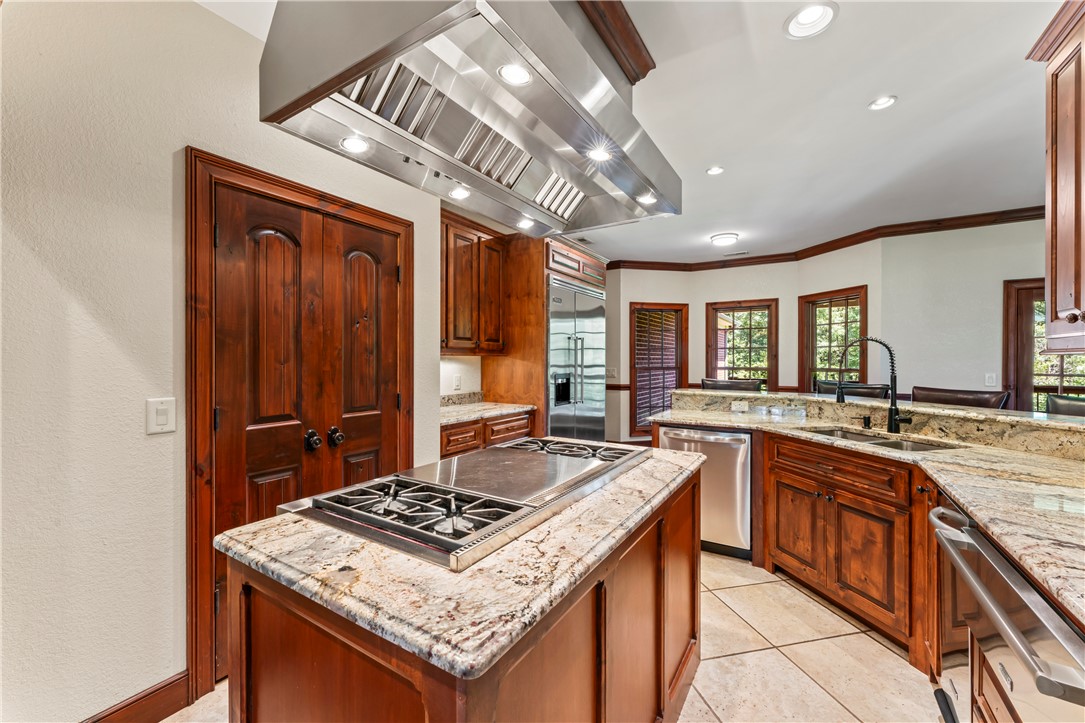 579 Terrapin Crossing Road Pickens, SC 29671 - Photo 10 of 50 A chef's dream, this kitchen features a 48 in gas cooktop island with a professional hood, 48 in built-in refrigerator, warming drawer, double ovens and built in microwave as well as a trash compactor