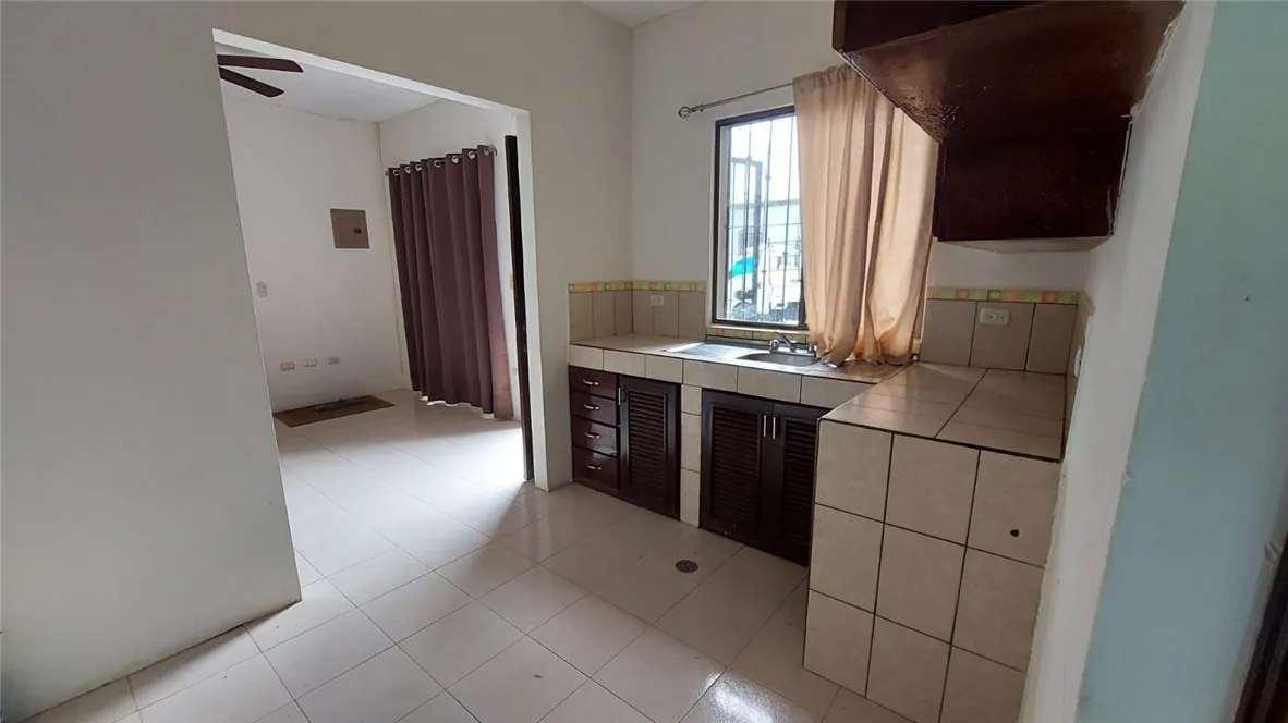 13 Masaya Highway Schenectady, OS 12345 - Photo 9 of 12 a kitchen with kitchen island cabinets and window