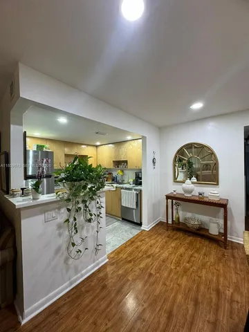 a living room with furniture a window and potted plants