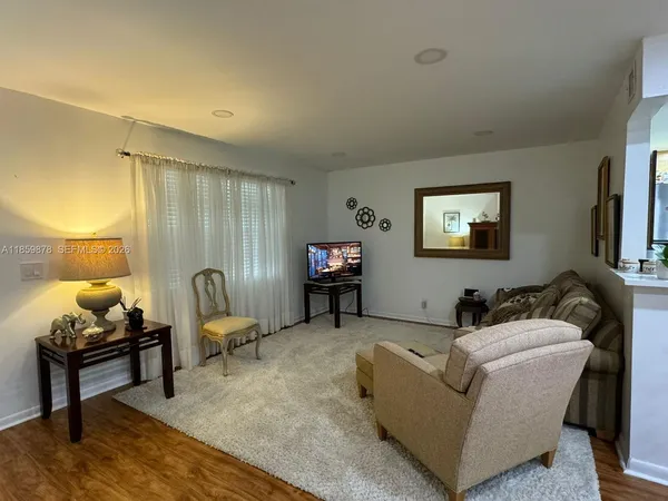 a living room with furniture and a lamp