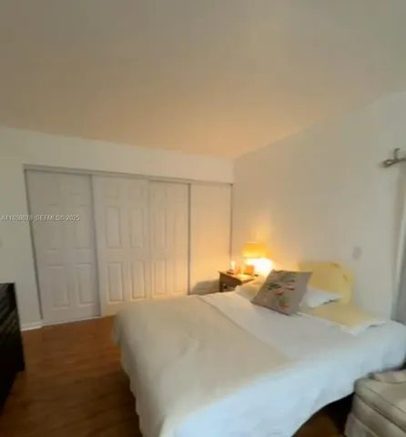 a bed sitting in a bedroom next to a cabinet