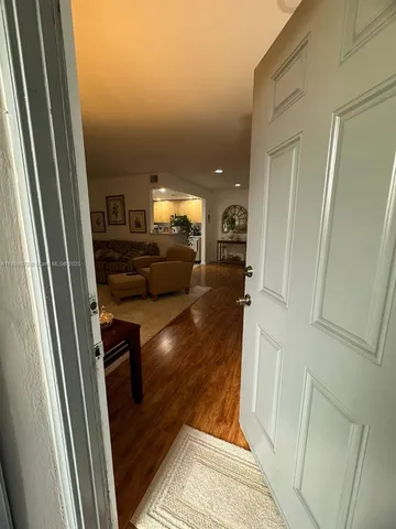 a view of living room with furniture and a fireplace