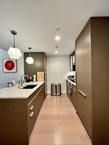 a large kitchen with a stove and a sink