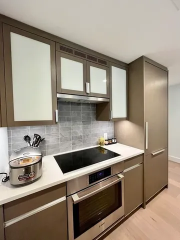 a kitchen with a sink and a refrigerator