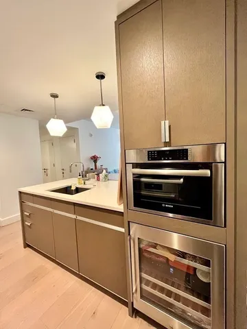a kitchen with stainless steel appliances a stove and a sink