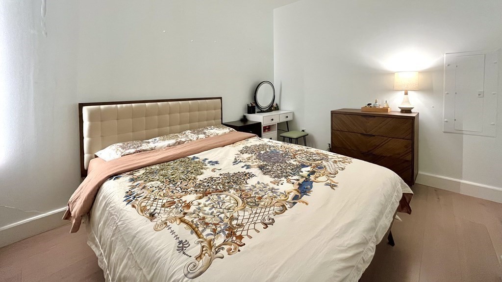100 Lovejoy Wharf, Unit 8M Boston, MA 02114 - Photo 15 of 37 a bedroom with a bed and a closet