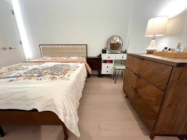 a bedroom with a bed and lamp