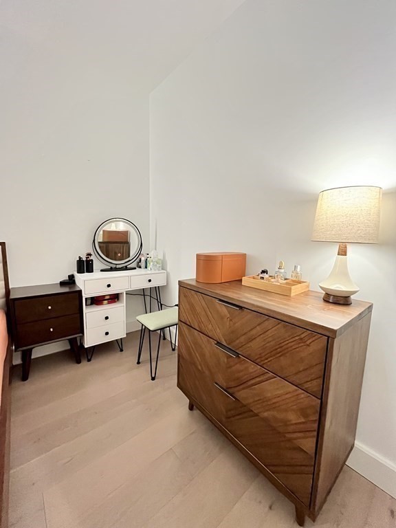 100 Lovejoy Wharf, Unit 8M Boston, MA 02114 - Photo 17 of 37 a bedroom with a bed and a lamp