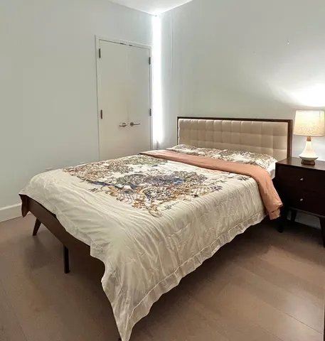 a bedroom with a bed and lamp