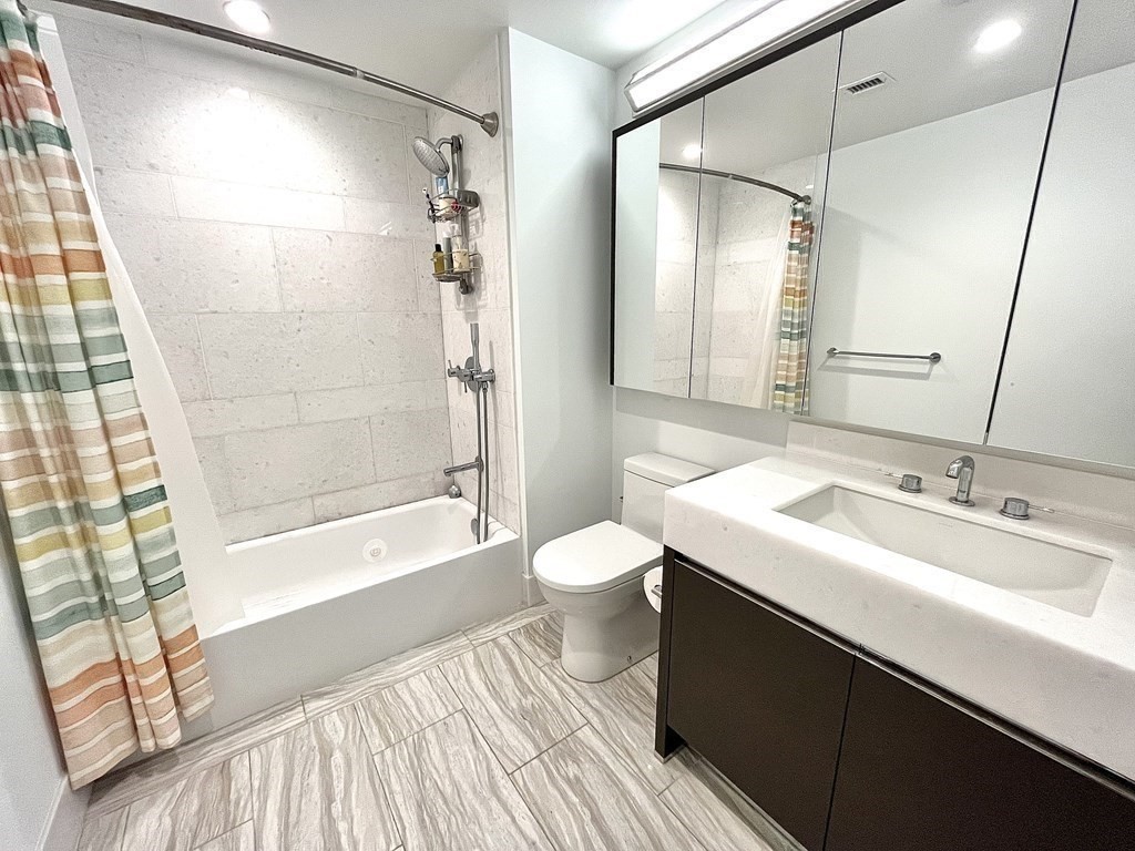 100 Lovejoy Wharf, Unit 8M Boston, MA 02114 - Photo 21 of 37 a bathroom with a sink a toilet and shower