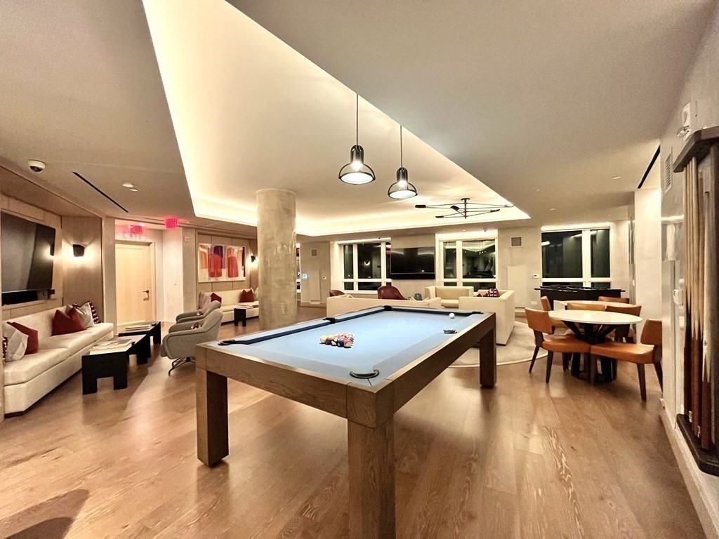 100 Lovejoy Wharf, Unit 8M Boston, MA 02114 - Photo 28 of 37 a living room with furniture pool table and flat screen tv
