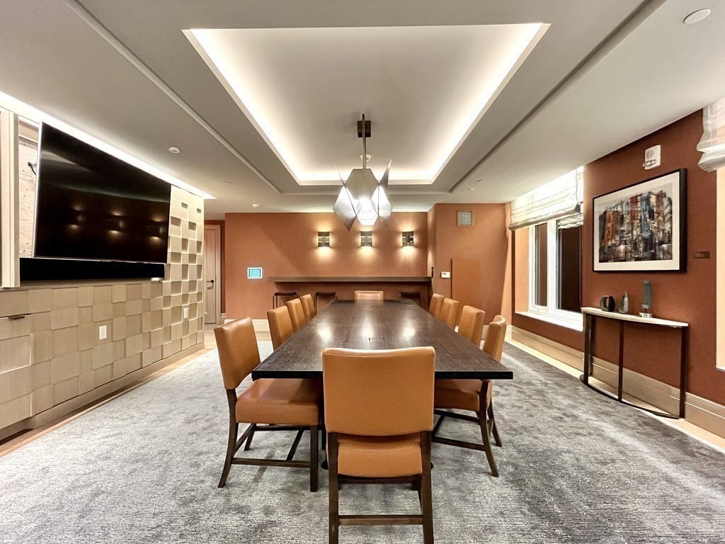 100 Lovejoy Wharf, Unit 8M Boston, MA 02114 - Photo 29 of 37 a view of a dining room with furniture