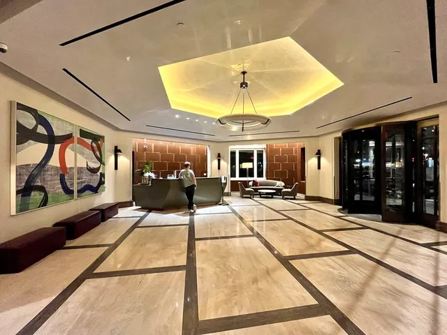 a room with gym equipment and large windows