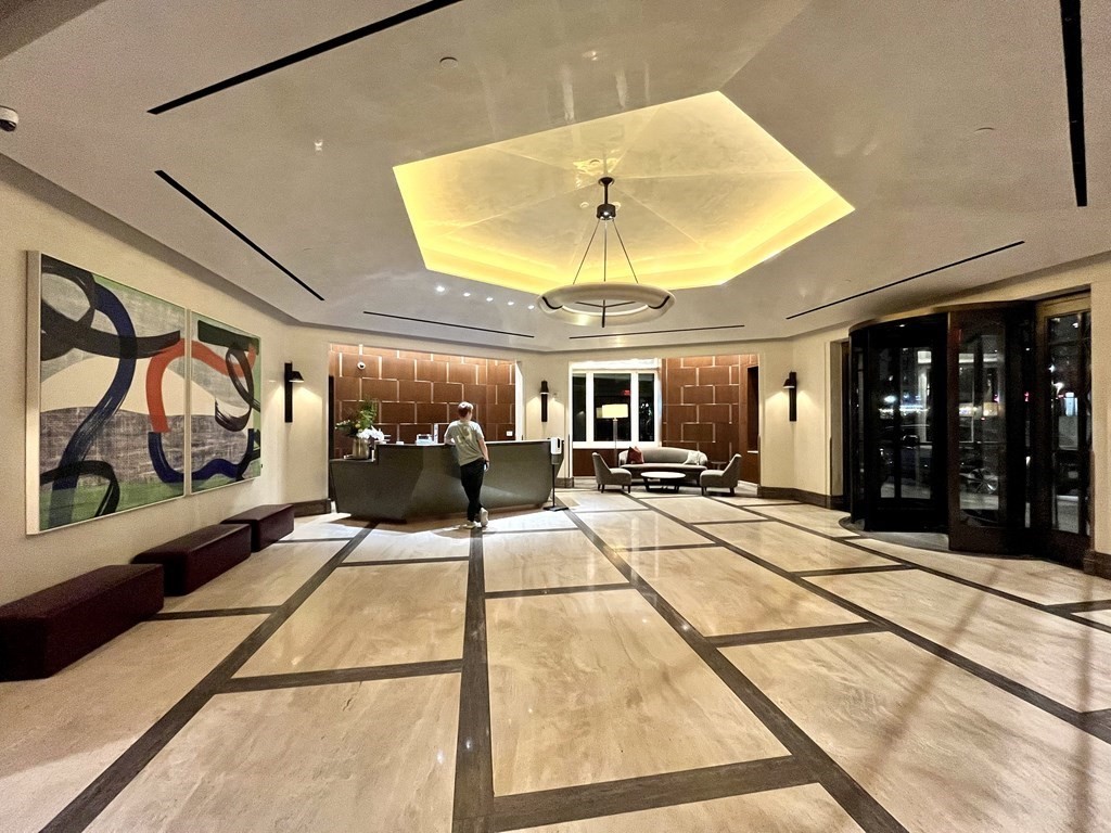 100 Lovejoy Wharf, Unit 8M Boston, MA 02114 - Photo 3 of 37 a room with gym equipment and large windows