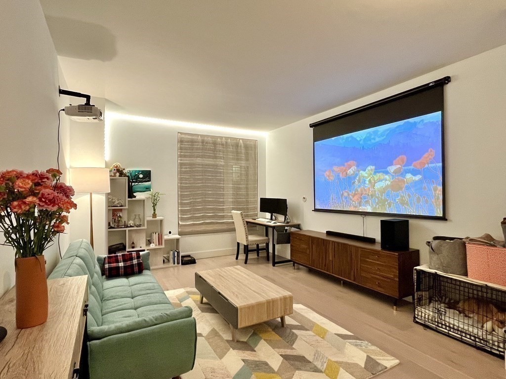 100 Lovejoy Wharf, Unit 8M Boston, MA 02114 - Photo 6 of 37 a living room with furniture and a flat screen tv