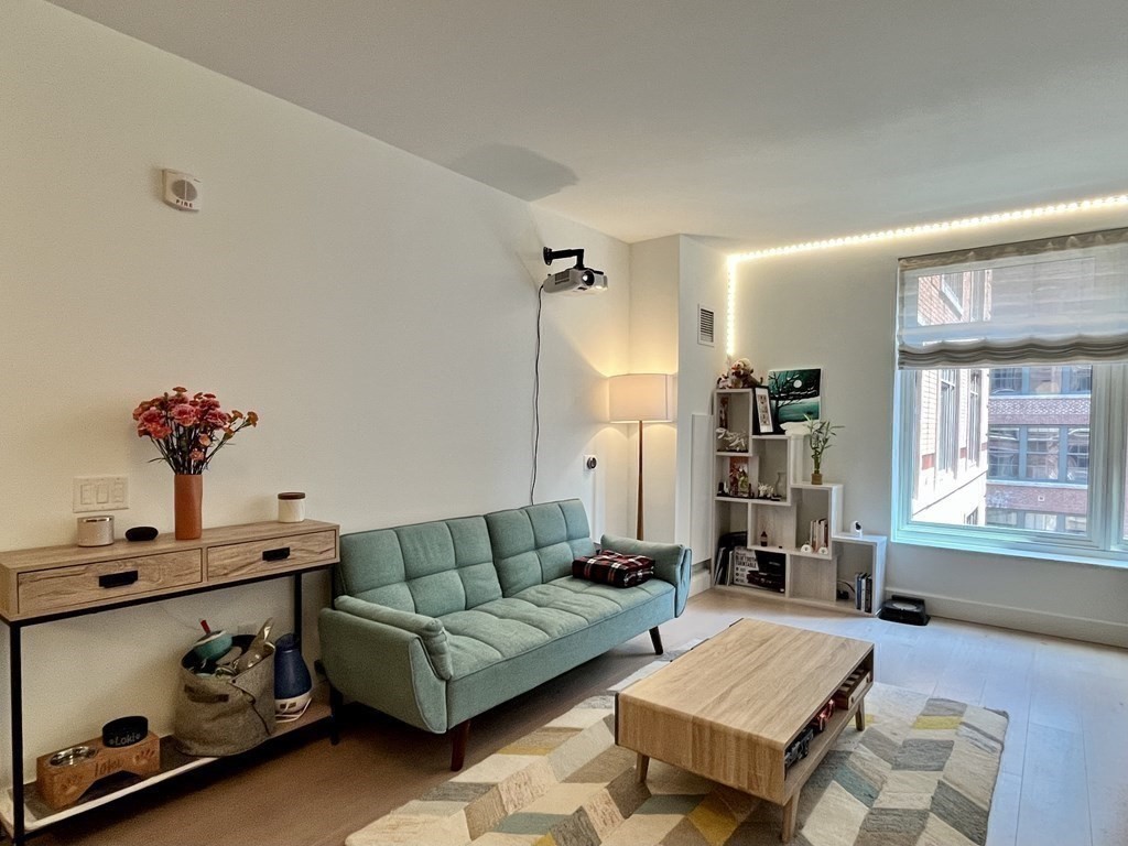 100 Lovejoy Wharf, Unit 8M Boston, MA 02114 - Photo 7 of 37 a living room with furniture and window