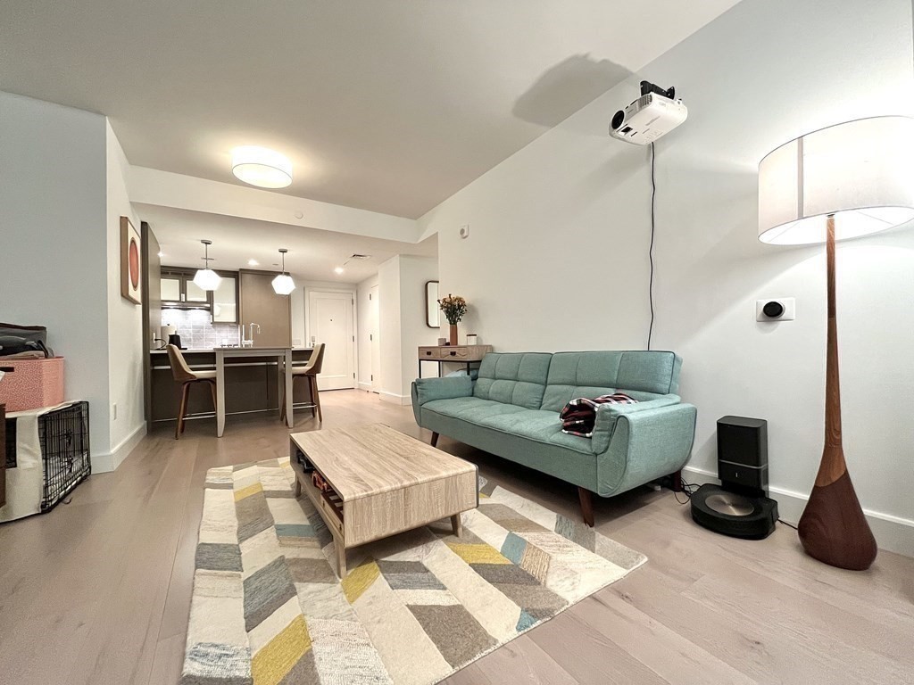 100 Lovejoy Wharf, Unit 8M Boston, MA 02114 - Photo 9 of 37 a living room with furniture and wooden floor