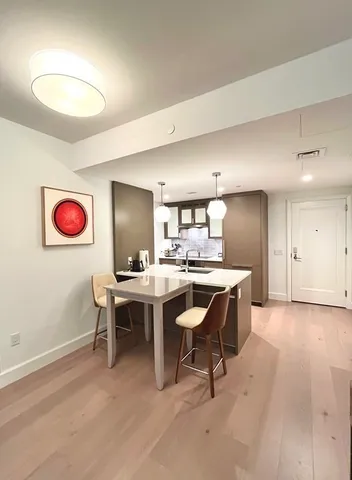 a view of a dining room with a table and chairs
