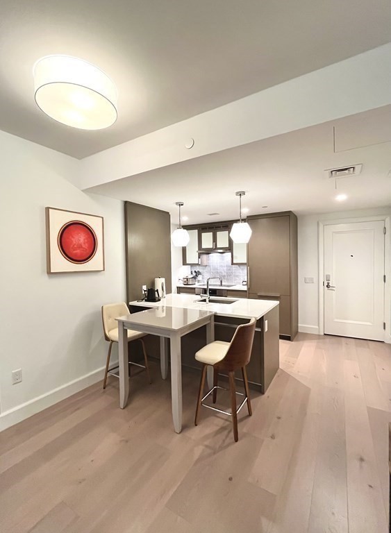 100 Lovejoy Wharf, Unit 8M Boston, MA 02114 - Photo 10 of 37 a view of a dining room with a table and chairs