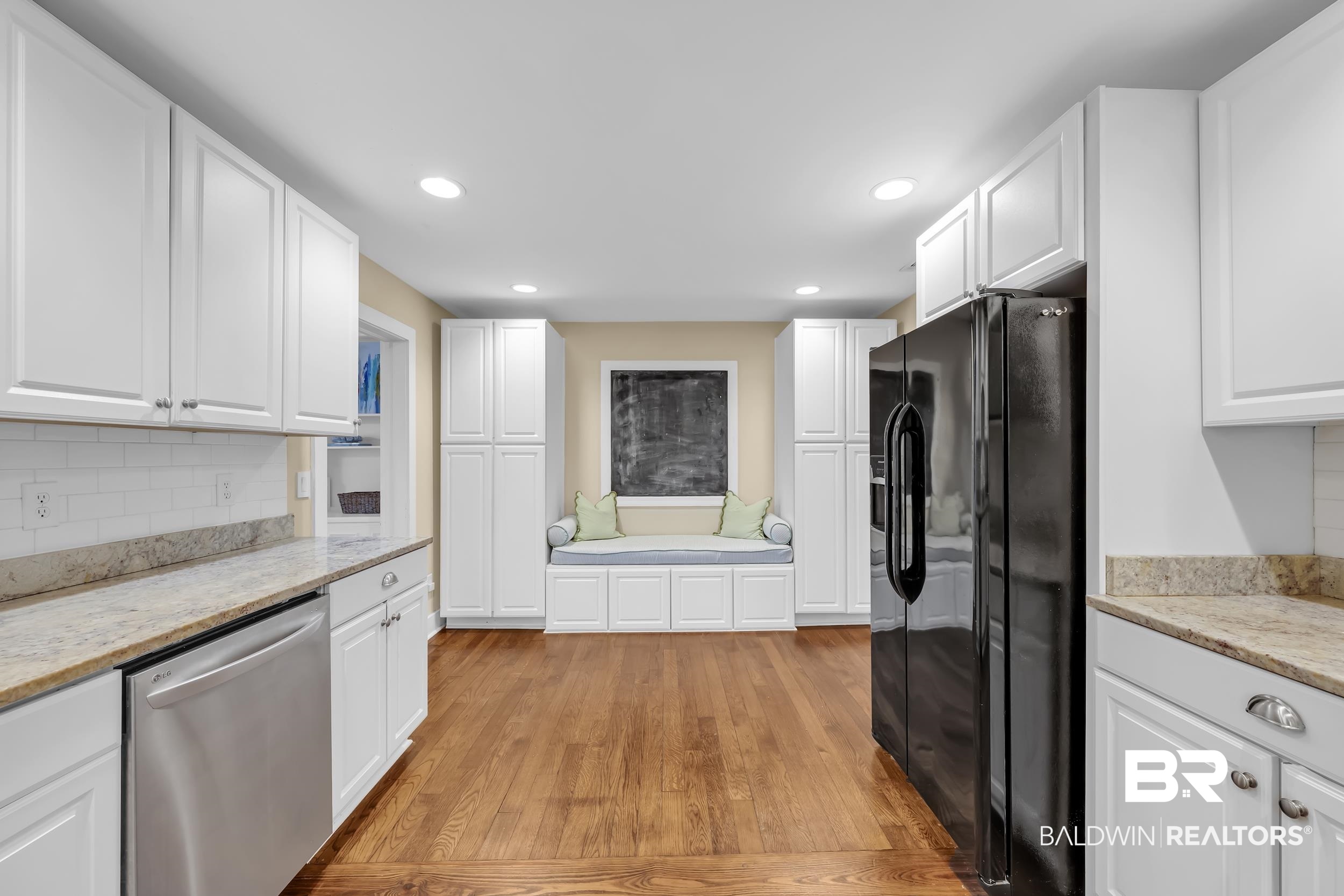 18 York Place Mobile, AL 36608 - Photo 10 of 27 Kitchen with white cabinetry, light wood-style floors, black fridge, dishwasher, and recessed lighting
