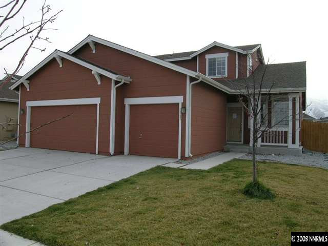9045 Andraste Way Reno, NV 89506 - Photo 1 of 8 a front view of a house with a yard and garage