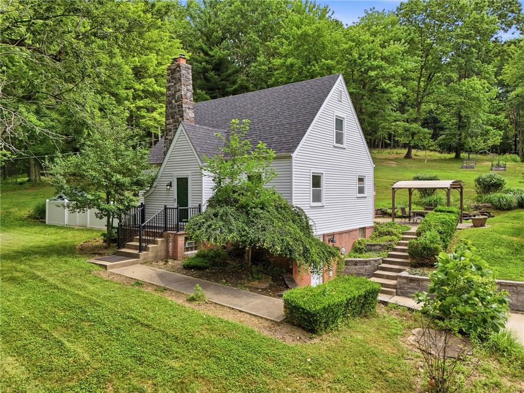 809 Franklin Road Mars, PA 16046 - Photo 1 of 44 Charming cottage exterior with stone chimney and mature landscaping
