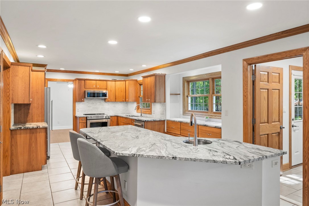 3871 Greentree Road Stow, OH 44224 - Photo 4 of 50 Kitchen featuring a large island with stone countertop and integrated sink