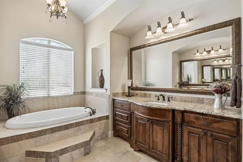 a bathroom with a granite countertop shower