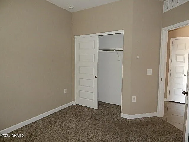 an empty room with closet area