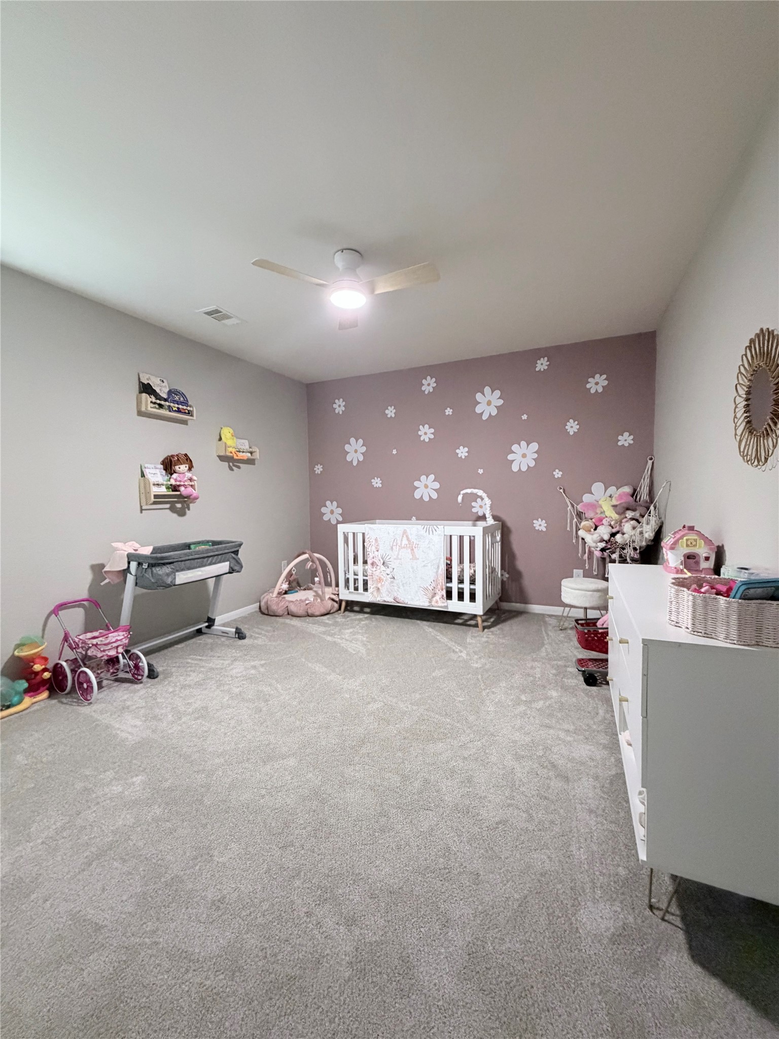 3226 Dappled Vale Trail Spring, TX 77373 - Photo 9 of 26 This is a cozy nursery with soft carpeting, decorated with a floral accent wall.